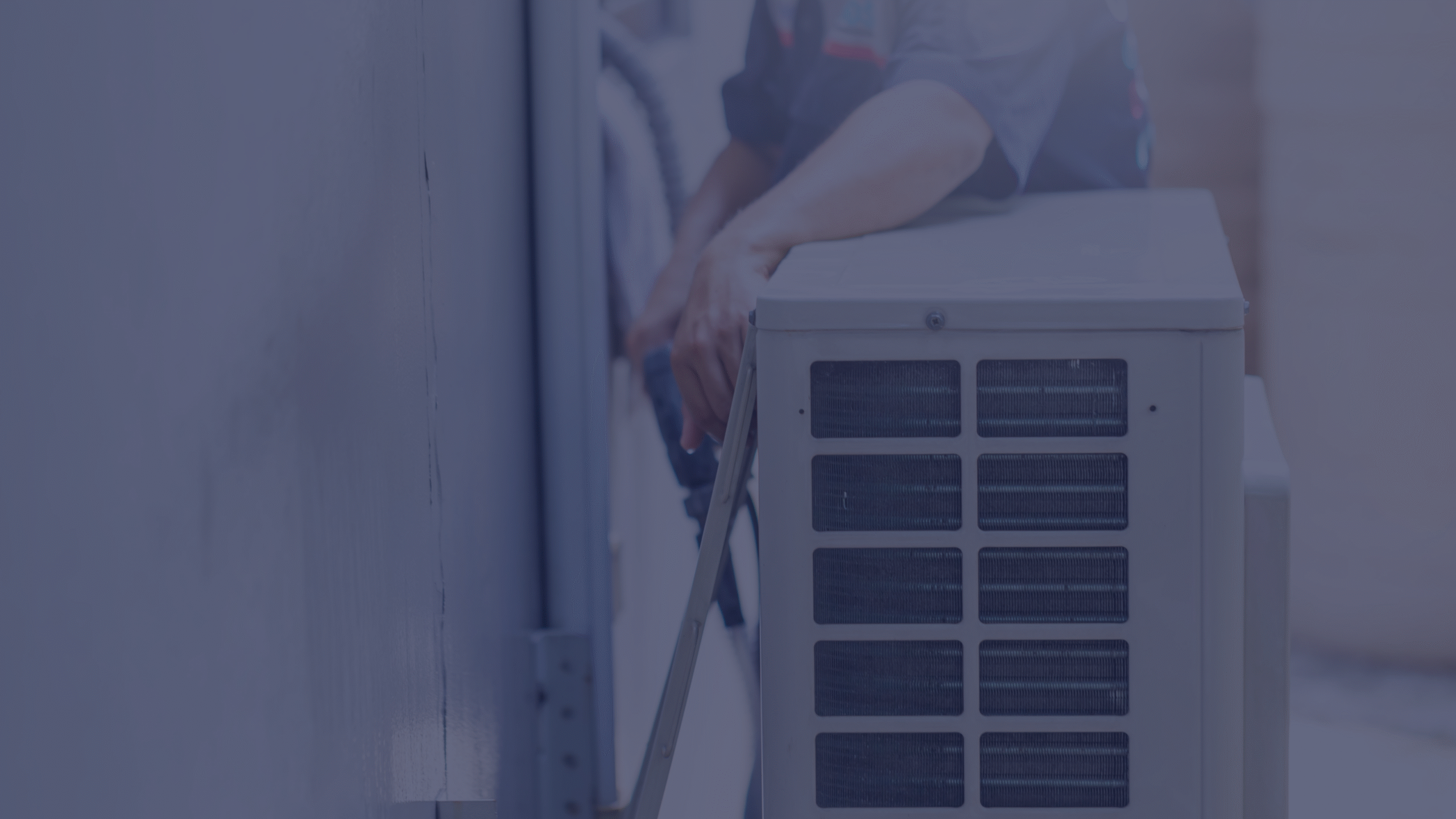 A maintenance technician checking an AC unit inside an apartment during summer